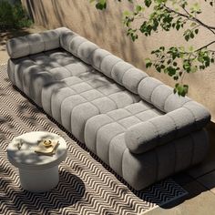 a large gray couch sitting on top of a rug