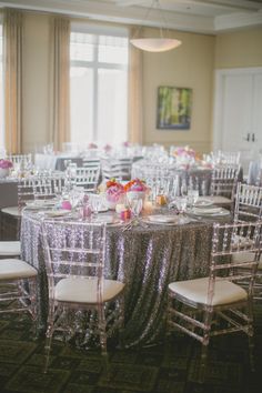 the tables are set with silver sequin tablecloths