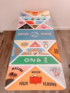 a multicolored area rug on the floor with various stickers all over it