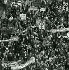 a large group of people holding signs and banners