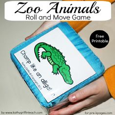 the zoo animals roll and move game is in someone's hand with an orange sweater