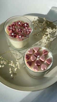 two bowls filled with hearts and flowers on top of a plate