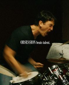 a man with his mouth open playing drums