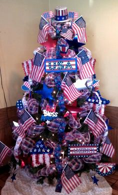 a christmas tree decorated with red, white and blue ribbon bows for the american flag