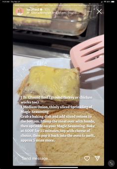 a piece of bread sitting on top of a white plate next to a pink spatula