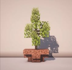 a small tree is shown in the shape of a brick planter with green leaves on it