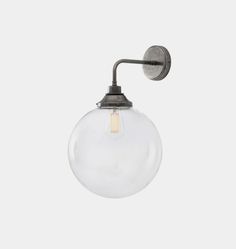 a light that is on the wall with a glass ball hanging from it's side