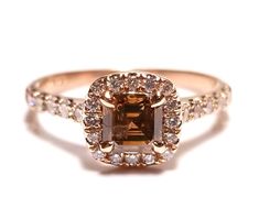 an engagement ring with a brown diamond surrounded by white diamonds