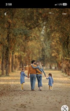 a family walking down a dirt road holding hands