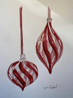 two red and white ornaments hanging on a wall