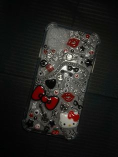 an iphone case with hello kitty and hearts on the back is covered in sequins