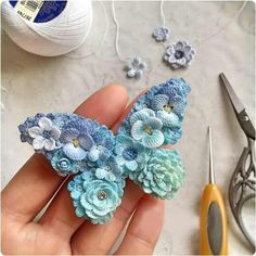 crochet flowers are being worked on by someone using scissors and yarn to make them