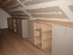 an empty room with some shelves and cupboards