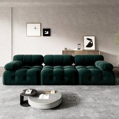 a modern living room with green velvet couches