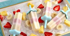 popsicles with strawberries, bananas and ice cream are on top of an ice tray