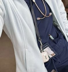 a man with a stethoscope on his neck is posing for the camera