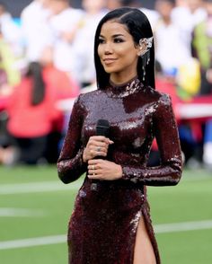 a woman in a sequin dress holding a microphone