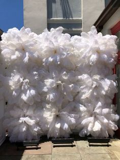 a large pile of white cotton sitting in front of a building