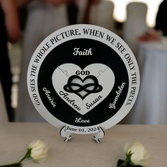 a white rose sitting on top of a table next to a sign that says faith