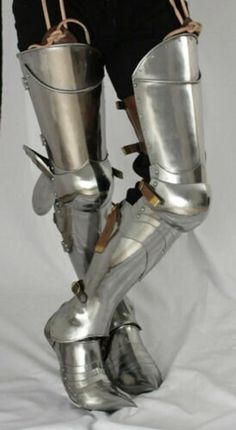 the legs and feet of a person in silver armor