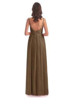 a woman in a long brown dress with her back turned to the camera, looking down