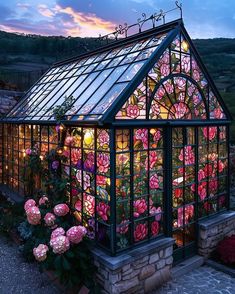 a glass house with pink flowers growing out of it