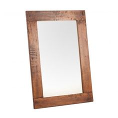 a wooden mirror sitting on top of a white wall