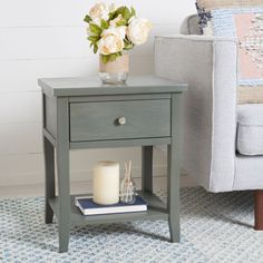 a small table with a candle and flowers on it