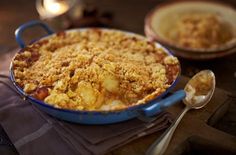 a casserole dish with crumbled toppings sits on a table