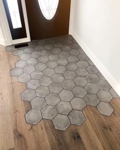 the floor is made up of hexagonal tiles and has a door in it