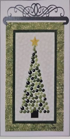 a card with a christmas tree on it and a star in the top right corner