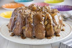 a bundt cake covered in nuts on a plate