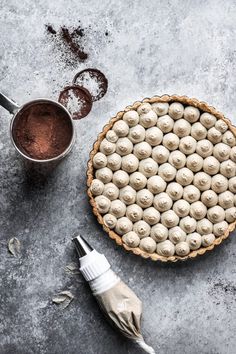 an overhead view of a pie with chocolates in the middle and other ingredients around it