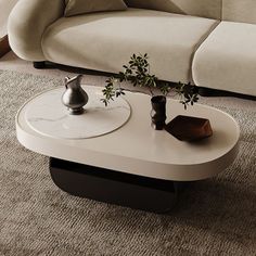 a white couch sitting next to a coffee table on top of a carpeted floor