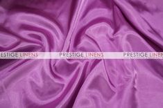 a purple satin fabric with the word prestige linens on it