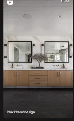 a large bathroom with two sinks and mirrors on the wall next to eachother