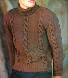 a young man wearing a brown sweater and hat