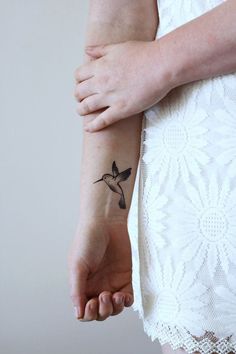 a woman with a small tattoo on her arm