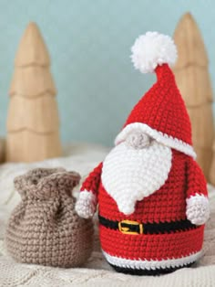 a crocheted santa clause hat sitting next to a stuffed animal