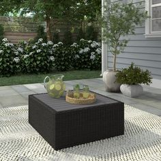 a patio with a table and potted plants