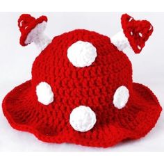 a crocheted red hat with white polka dots