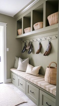 a bench with some shoes on it and baskets hanging from the wall above them in front of a door