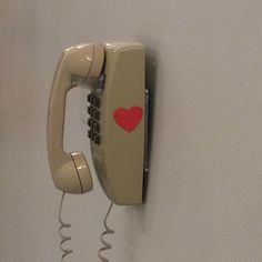 an old style phone with a heart on it