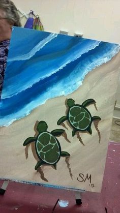 a painting of two turtles on the beach