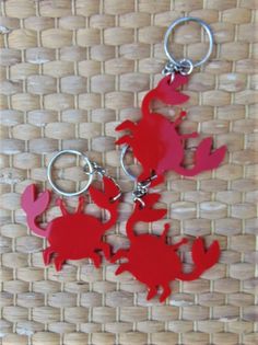 three red and pink sea animals are on a woven surface