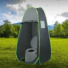 a portable toilet in the middle of a field