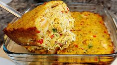 a casserole dish with meat and vegetables being lifted from the casserole