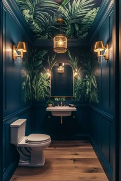 a bathroom with a toilet, sink and green wallpaper on the walls in it