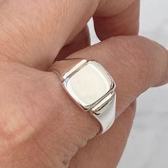 New in!  Made to order. Please allow 3 weeks before being ready to post.  Solid silver cushion signet ring- mirror polished finish  Ring sizes available - J to X - 4 3/4 - 11 1/2 # Hand engraving available #  Please contact for a quote!  Face size - 13mm x 10.5mm  Weight - 7g ( size x )  Hallmarked with this years mark Brand new condition!   The signet ring comes in a lovely vintage style ring box! Please make contact if you have any questions regarding the item! Follow Heirlooms & Signets on Instagram for the latest updates - https://www.instagram.com/heirloomsandsignets/ Thank You Hannah Classic Sterling Silver Rectangular Signet Ring, Classic Rectangular Sterling Silver Signet Ring, Silver Classic Signet Ring For Formal Occasions, Classic Silver Signet Ring For Formal Occasions, Modern Square Cut Signet Ring With Polished Finish, Elegant Adjustable Signet Ring With Polished Finish, Modern Adjustable Signet Ring For Formal Occasions, Modern Formal Signet Ring, Classic Engraved Sterling Silver Signet Ring