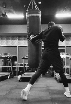 a man is practicing boxing in the gym